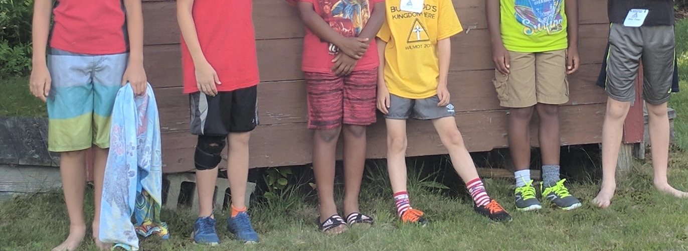 Campers leaning against building