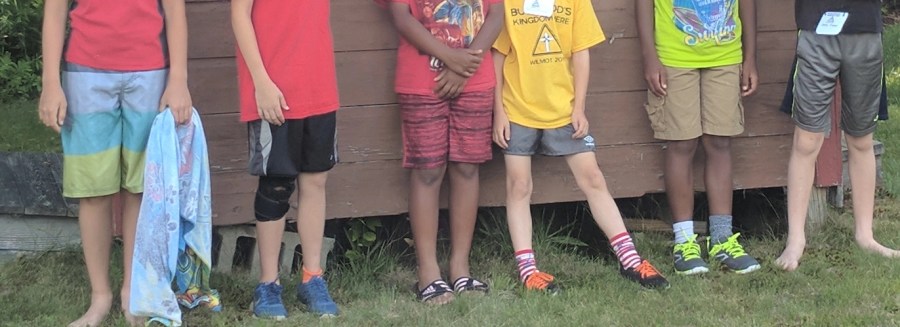 Campers leaning against building