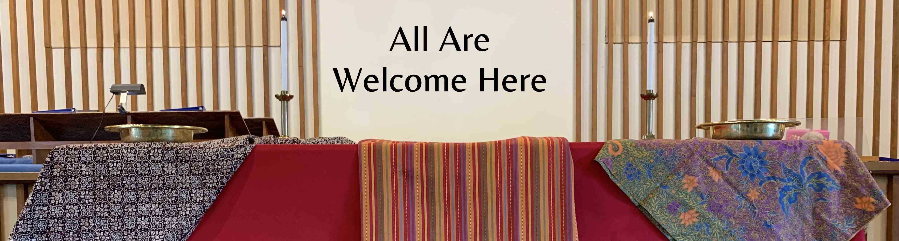 Communion table with text "All are welcome here"