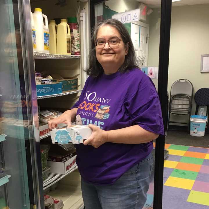 Woman putting food in commercial refrigerator