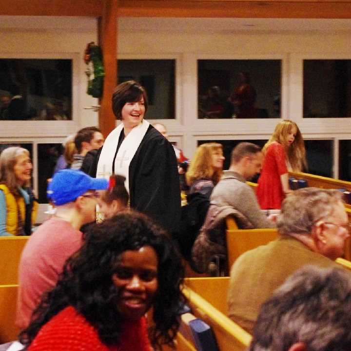 Pastor and worshipers in sanctuary